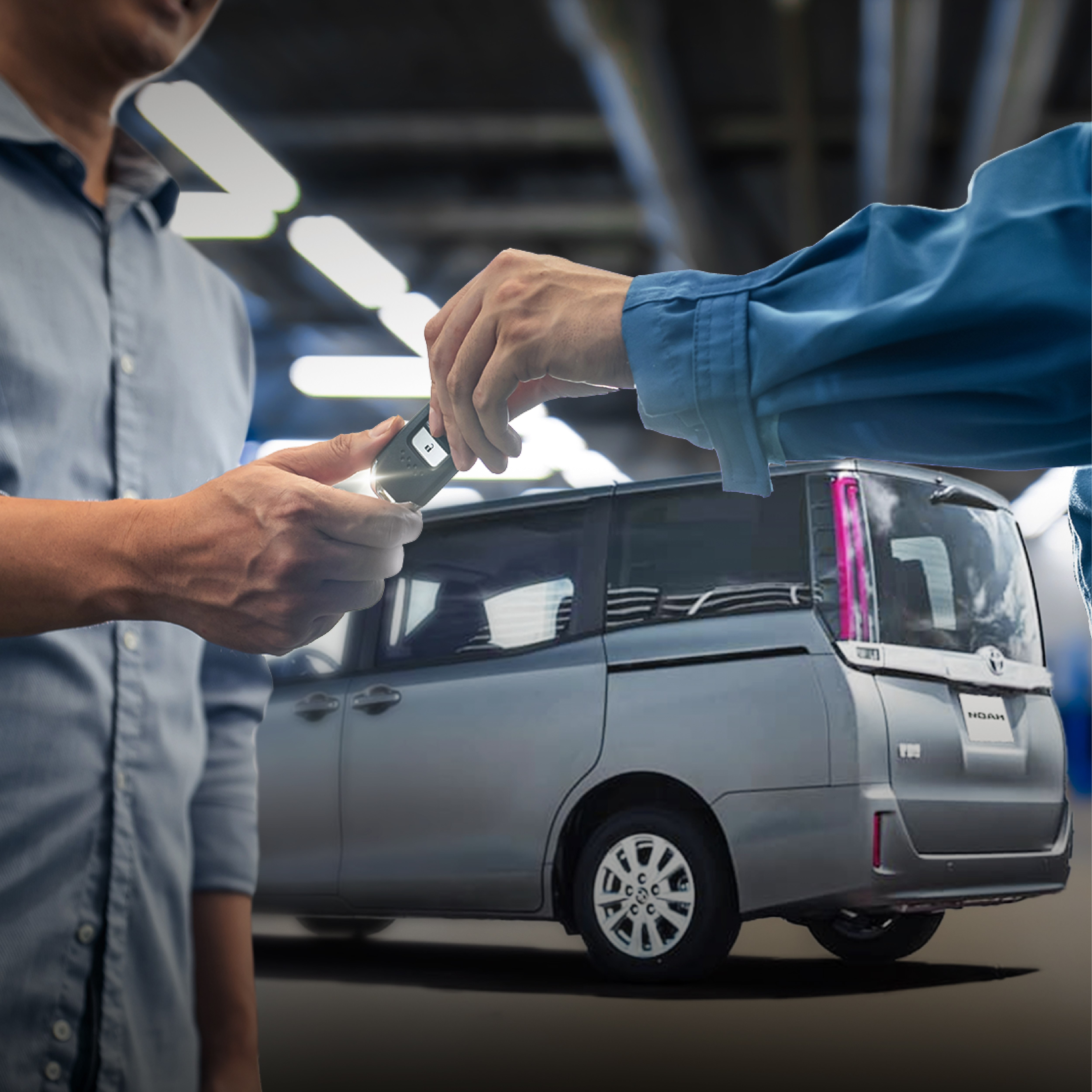 man passing car keys to customers